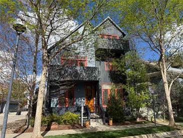 Charming modern home featuring an orange door, vibrant windows, and a multi-story design at 920 Neon Forest Cir, Longmont, CO 80504