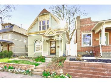 Charming home featuring unique architectural details and a well-manicured front yard, welcoming you to a comfortable living space at 3337 Decatur St, Denver, CO 80211