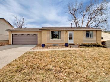 Charming ranch-style home featuring a two-car garage, xeriscaping, and neutral brick and siding at 6523 S Field Way, Littleton, CO 80123