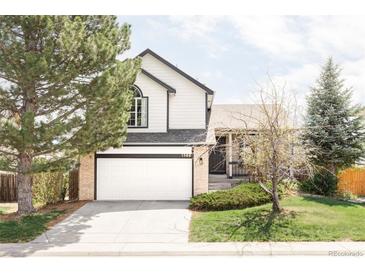 Charming two-story home featuring a brick and siding exterior with an attached two-car garage at 1566 S Richfield Way, Aurora, CO 80017