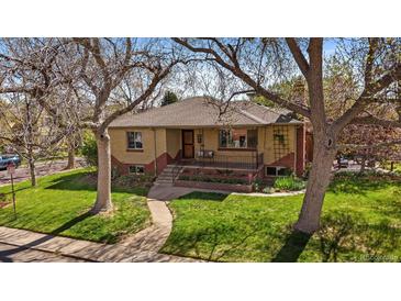 Charming brick home with well-manicured lawn, mature trees, and inviting front porch at 3540 Vrain St, Denver, CO 80212