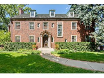 Brick home with landscaped lawn and walkway at 869 Vine St, Denver, CO 80206