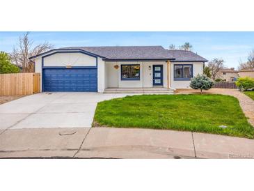 Charming ranch home featuring a blue garage door and trim, a well-manicured lawn, and freshly painted white brick at 2484 E 101St Ct, Thornton, CO 80229