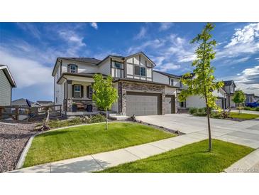 Charming two-story home with stone accents, a three-car garage, and a well-manicured front lawn at 5392 Sanctuary Ave, Firestone, CO 80504