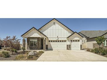 Charming two-story home featuring a three-car garage, stone accents, and a well-maintained front yard at 21701 E 50Th Dr, Aurora, CO 80019