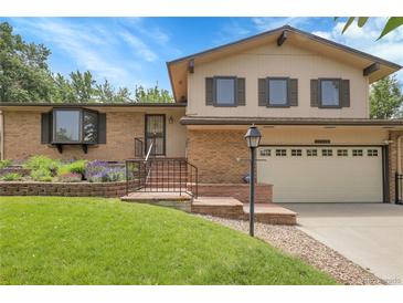 Charming two-story home with a brick exterior, landscaped front yard and well manicured lawn at 11936 E Oregon Cir, Aurora, CO 80012
