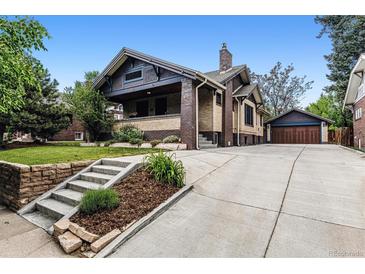 Charming brick home with landscaped front yard, long driveway, and detached garage at 3145 W 31St Ave, Denver, CO 80211