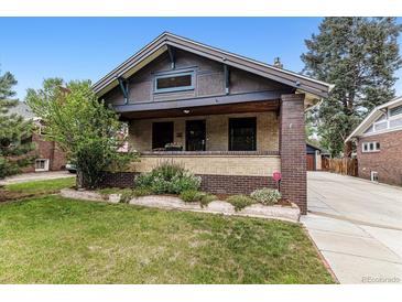Charming bungalow-style home with well-maintained front yard and inviting front porch with brick and stone accents at 3145 W 31St Ave, Denver, CO 80211