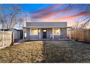 Charming bungalow-style home with a cozy front porch and well-maintained lawn at 3930 W Kentucky Ave, Denver, CO 80219