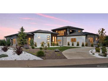 Beautiful exterior elevation of the home with landscaping and modern design elements at 6915 Tremolite Dr, Castle Rock, CO 80108