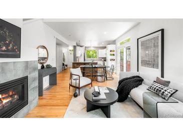 Inviting living room with fireplace, modern furnishings, and hardwood floors at 1947 King St, Denver, CO 80204