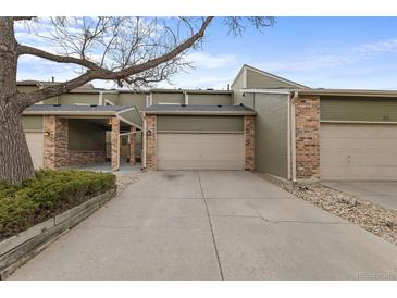 Charming townhome featuring an attached garage, well-maintained landscaping, and a private driveway at 4825 S Ammons St # 113, Littleton, CO 80123