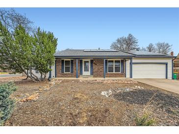 Charming single story home with brick accents and solar panels in a quiet neighborhood with a manicured front yard at 17148 E Evans Dr, Aurora, CO 80013