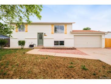 Charming two-story home with white siding, new front yard and attached two car garage at 2988 S Hannibal St, Aurora, CO 80013