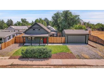 Charming craftsman home with a detached garage and well-manicured lawn at 2310 S Decatur St, Denver, CO 80219