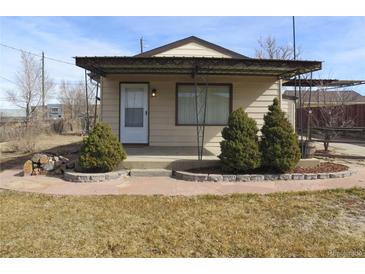 Charming single story home with a covered porch and landscaped front yard in a quiet neighborhood at 5660 Olive St, Commerce City, CO 80022