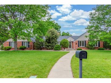 Charming brick home with a lush green lawn and inviting walkway at 3 Glenview Dr, Littleton, CO 80123