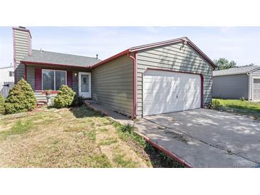 Charming single-story home with a front yard and attached garage, offering curb appeal at 19335 E Batavia Pl, Aurora, CO 80011