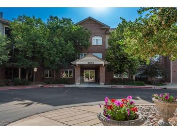 Attractive brick building with well-maintained landscaping and inviting entrance at 2896 W Riverwalk Cir # 204, Littleton, CO 80123