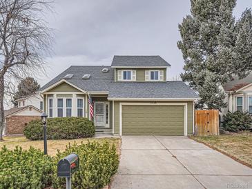 Green two-story house with attached garage and landscaped front yard at 2368 W 119Th Ave, Denver, CO 80234