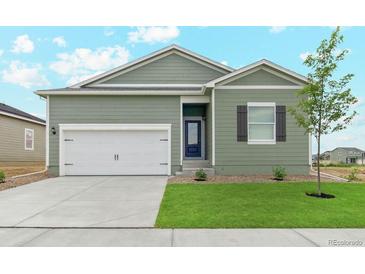 Charming single-Gathering home featuring a two-car garage and a well-manicured front lawn at 2151 Christina St, Fort Lupton, CO 80621