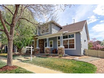 Charming two-story home with a beautifully landscaped front yard and stone pillar accents at 14214 Lakeview Ln, Broomfield, CO 80023