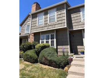 Charming two-story home featuring mature landscaping, neutral paint, and large windows for natural light at 9636 W Chatfield Ave # C, Littleton, CO 80128