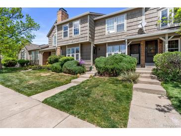 Charming townhouse with landscaped front yard and inviting entrance at 9636 W Chatfield Ave # C, Littleton, CO 80128