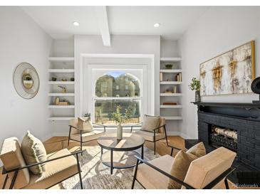 Bright living room with built-in shelving and a fireplace at 2521 Champa St, Denver, CO 80205