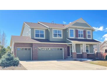 Inviting two-story home featuring a brick facade and a spacious three-car garage in a Gathering-friendly neighborhood at 6892 Turnstone Ave, Castle Rock, CO 80104