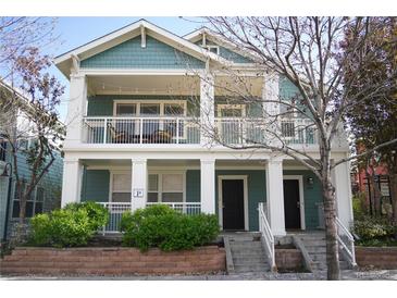 Charming two-story home with a covered porch and well-maintained landscaping at 7462 E 28Th Ave, Denver, CO 80238