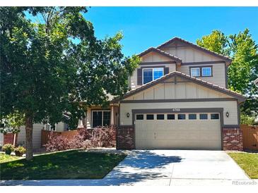 Charming two-story home featuring a two-car garage, mature trees, and a well-maintained lawn at 4788 Laurelglen Ln, Highlands Ranch, CO 80130