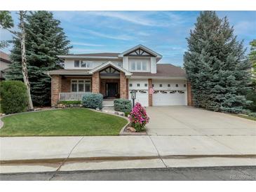 Charming two-story home with brick accents, manicured lawn, and well-maintained landscaping at 7053 S Shawnee St, Aurora, CO 80016