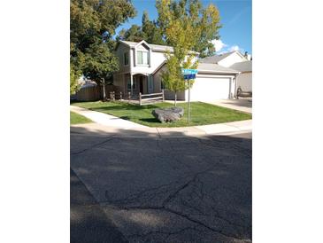 Charming two-story home with a well-maintained lawn and a two-car garage at 8094 Kline Ct, Arvada, CO 80005