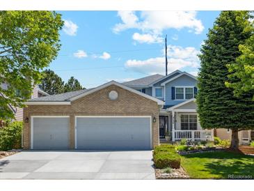 Charming two-story home with a brick-accented garage and well-manicured front yard at 5134 S Ouray Ct, Centennial, CO 80015