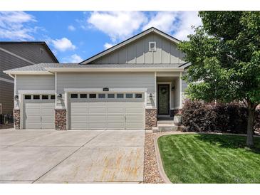 Charming home featuring a three-car garage and inviting front yard landscaping at 3406 Quicksilver Rd, Frederick, CO 80516