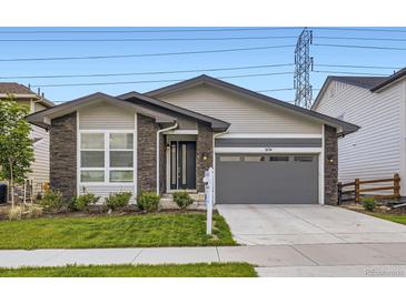 Charming single-Gathering home with a well-maintained lawn and inviting stone accents at 5134 Queen Ct, Arvada, CO 80002