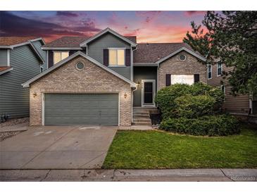 Charming two-story home featuring a brick and siding exterior, a two-car garage, and a well-maintained front yard at 359 Wessex Cir, Highlands Ranch, CO 80126