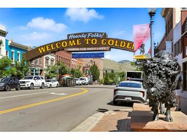 View of the Welcome to Golden sign with a statue of a bison and buildings on a sunny day at 409 Lookout View Dr, Golden, CO 80401