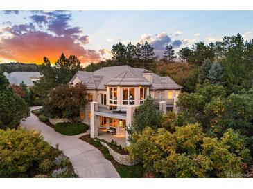 Stunning two-story home featuring balconies, lush landscaping, and a private driveway for a luxurious living experience at 724 Evening Star Dr, Castle Rock, CO 80108