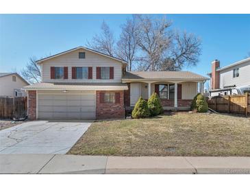 Charming two-story home with brick accents, a two-car garage, and a well-maintained front yard at 6823 Coors St, Arvada, CO 80004