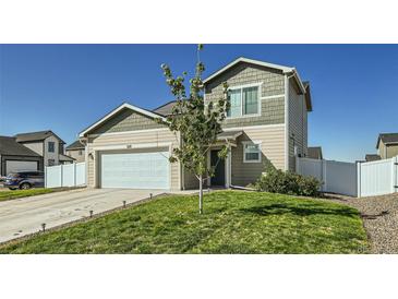 Charming two-story home showcasing a well-maintained lawn, two-car garage, and inviting curb appeal at 529 Beckwourth, Fort Lupton, CO 80621