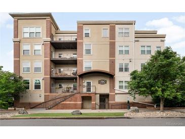 Multi-story condo building featuring brick accents, balconies and well-kept landscaping at 1780 N Washington St # 305, Denver, CO 80203