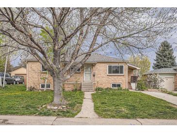 Charming brick home with a well-maintained lawn and mature tree in a quiet neighborhood at 2710 Zenobia St, Denver, CO 80212
