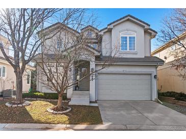 Charming two-story home with a well-manicured front yard and a two-car garage, perfect for suburban living at 11989 E Lake Cir, Greenwood Village, CO 80111