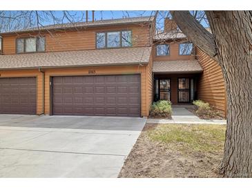 Inviting two-story townhouse featuring a private garage and a charming front entrance with beautiful wood siding at 2263 E 129Th Ave, Thornton, CO 80241