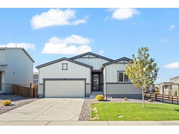 Charming single-story home with a well-manicured lawn and attached two-car garage at 1868 Homestead Dr, Fort Lupton, CO 80621