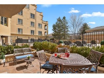 Inviting patio with comfortable seating, perfect for outdoor relaxation and entertaining with lush landscaping around it at 2500 E Cherry Creek South Dr # 116, Denver, CO 80209