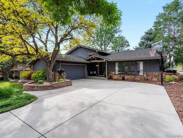 Charming single-Gathering home featuring a spacious driveway, stone accents and professional landscaping at 7055 E Heritage S Pl, Centennial, CO 80111