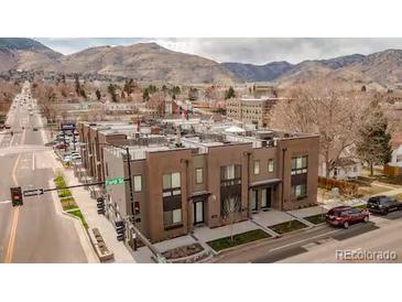Beautiful exterior view of the townhomes, highlighting their modern design and rooftop decks, set against a mountain backdrop at 1884 Ford St, Golden, CO 80401